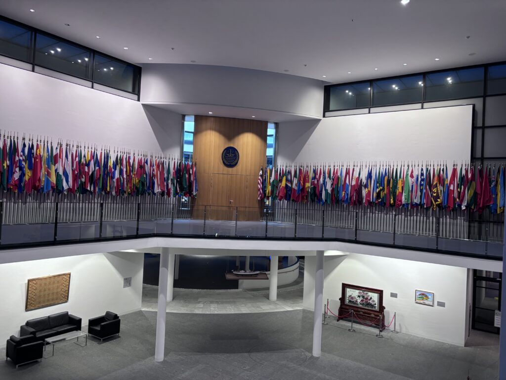 View of the atrium of the offices, with UN flags either side of large wooden door
